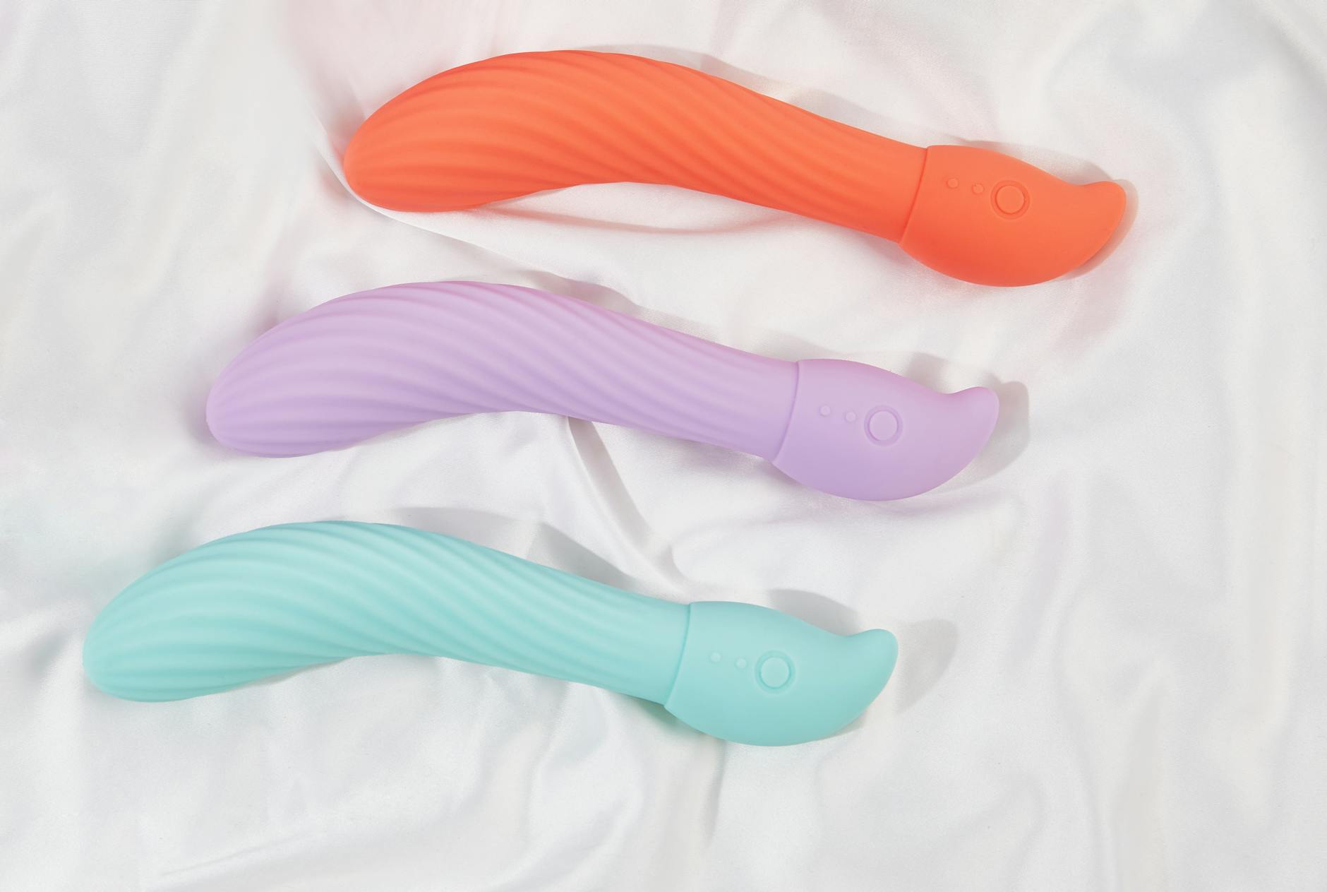 A hand holding a vibrator against a purple backdrop, symbolizing reclaiming pleasure and intimacy after stress
