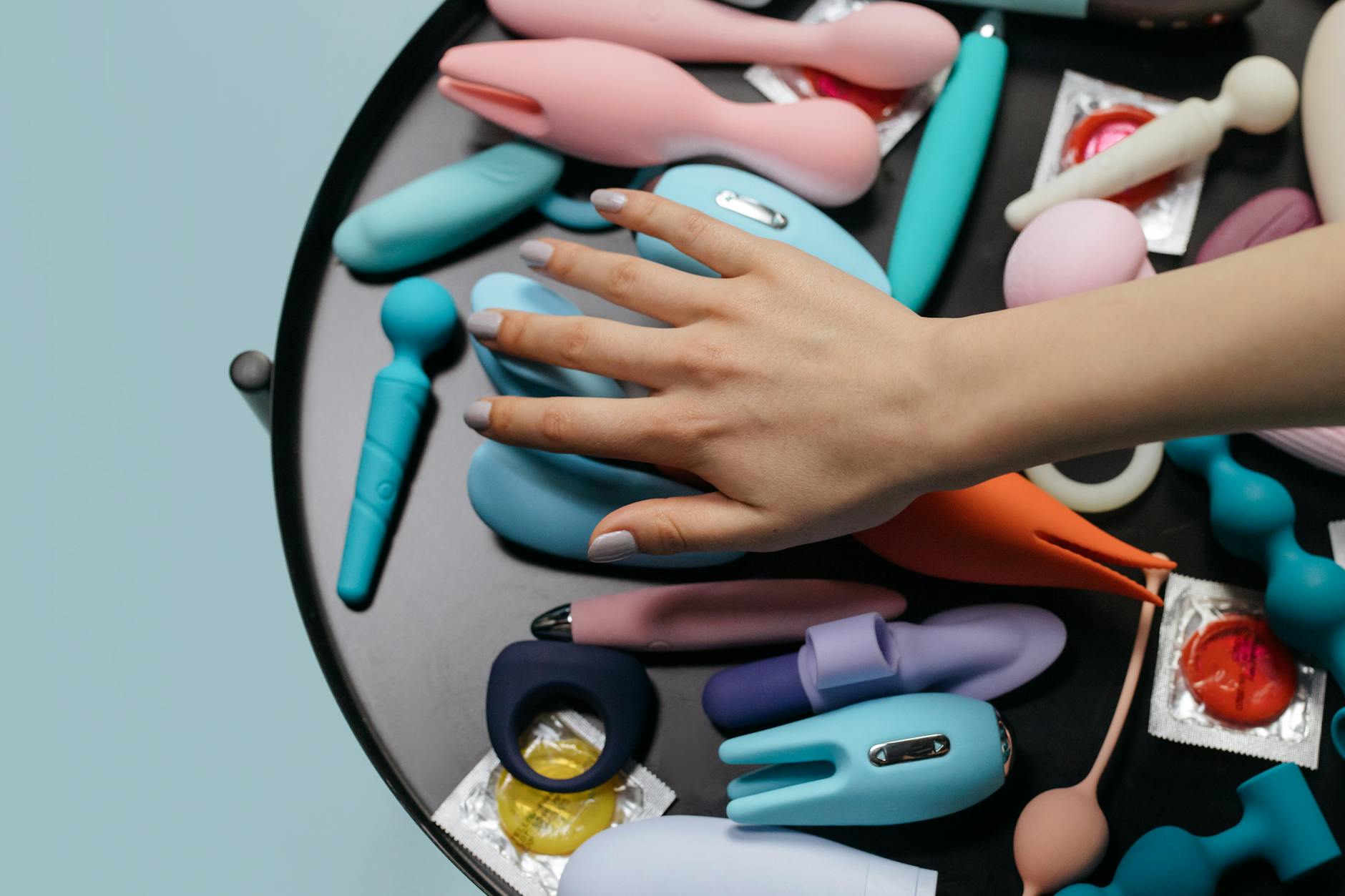 A hand holding a vibrator against a purple backdrop, symbolizing sensual reconnection.